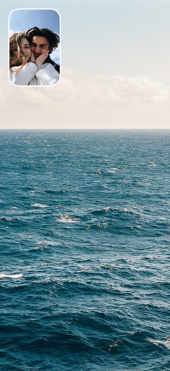 Dual photo: the sea, a couple’s selfie in the corner window